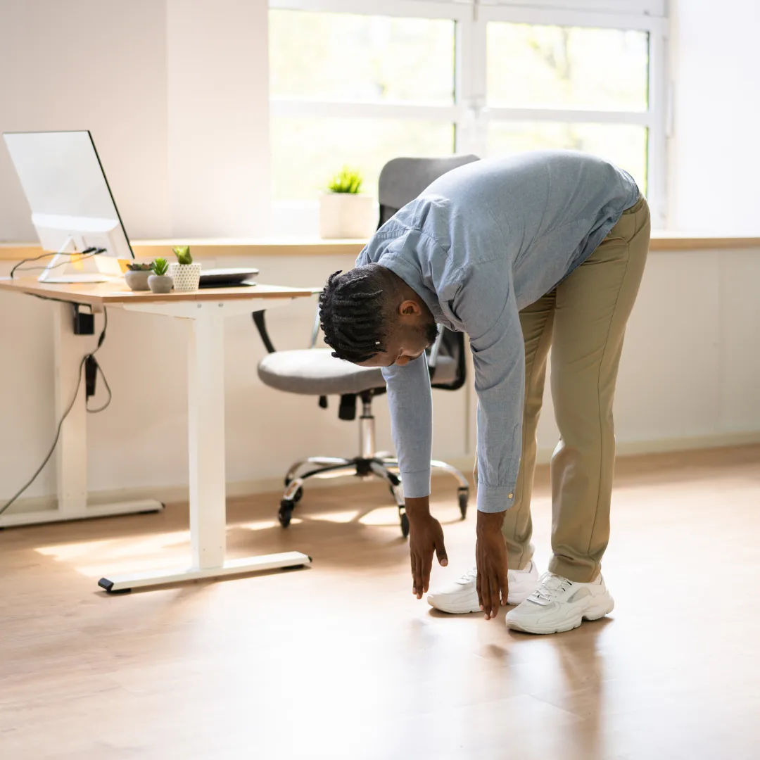 Person stretching at a desk